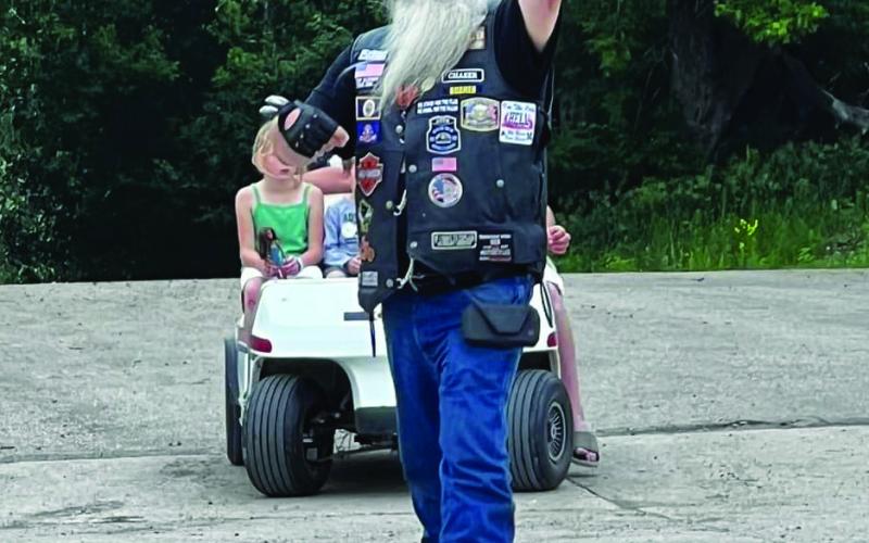 Randy “Boomer” Hills doing what he does best - assisting with one of Drayton’s recent motorcycle rides. Photo by Sandy Kovar at ShaBu22 Photography.