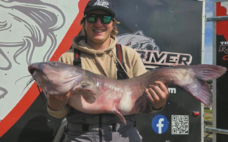At 26.75 pounds, Zach Erickson, shows off the largest fish of the tournament. Photo by Rob Boll.