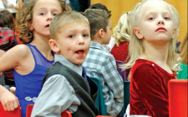 As the children entered the gymnasium they started looking for their loved ones. Pictured left to right are 2nd grade students Kendall Lizakowski, Shawn Patterson, and Nora Hillier. VNV Photo by Lesa Van Camp