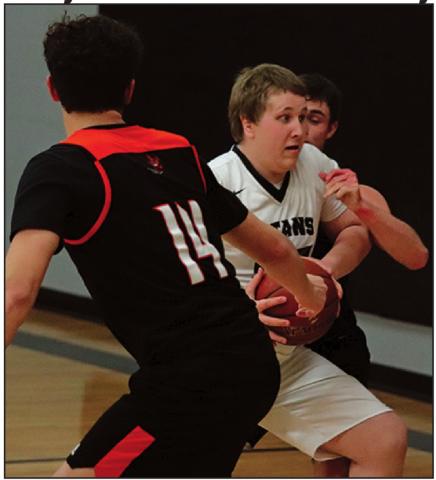 Lukas Pastorek tries to maintain possesion of the ball against Adre Carrier and another Tornado. VNV Photo by Lesa Van Camp