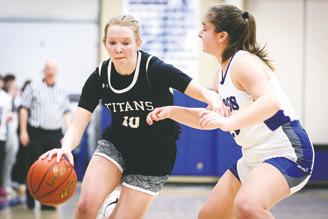 Easton Larson drives by a defender in Friday's Region 2 Play-in game in Hillsboro. Photo courtesy of Corey Erickson, Hillsboro Banner.