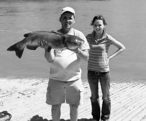 Mike with daughter, Breanna and their monster catfish caught in 2009. Submitted photo.