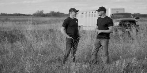 Cory Hepola [left] speaks with Kevin Leier of Heartland Bison Ranch. Photo by The Brookshire Company.