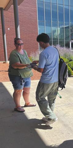 High school students unlock magnetic locking pouches containing their phones after class with a newly established a phonefree policy in 2024. After the success of cellphone bans nationwide, state lawmakers are turning to legislation restricting how much time students can look at screen. (Alixel Cabrera/Utah News Dispatch)