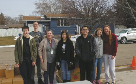 Local students volunteered at the Great Plains Mobile Food Bank held in Drayton on March 20. They worked to unload the truck and distribute food parcels to families The event is sponsored by Drayton's FCCLA and National Honor Society groups. Pictured from left to right: Loki Sylskar, Jonah Rarick, Mrs. Quimby, Brookelynn Petersen, Gunnar Kuznia, Violet Hoyles, and Peyton Larson. Their next mobile food bank will be on June 19 at the front of Drayton school. Submitted photo