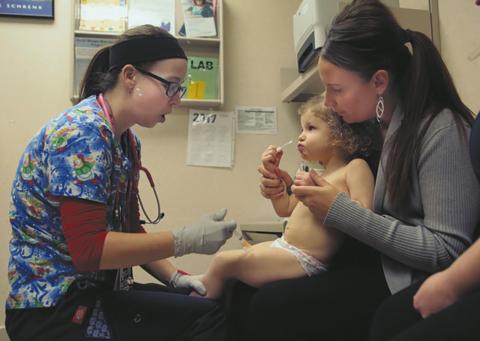 Nurse Julianna Emanuel administers a hepatitis A vaccine shot at the Sanford Children's Clinic in Fargo. Photo by Dave Wallis, courtesy of The Forum.
