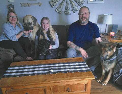 Freeway, far right, sits with his newly adoptive family: (L to R) Jamie, Max, Rylee holding Jack (who is a blind rescue dog), Harper and Ian.