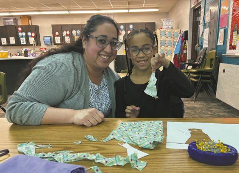 The youngest member of the club, Mia Johnson is making a Barbie prom dress with the assistance of her mother, Yvonne. Photo by Andrea Johnston