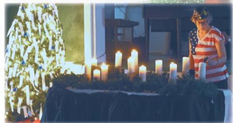 Kristi Scharmer lit the candles and read the names at the Tree of Lights service. Photo by Lyle Van Camp