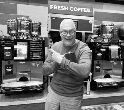 Bob gives an enthusiastic endorsement of his favorite coffee machine at Love’s Travel Stop, mug in hand and pointing to the Swiss-made Schaerer brewer behind him.