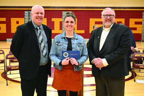 Randy Richards (left), policy director for U.S. Senator Kevin Cramer, and Tom Brusegaard (right), regional director for U.S. Senator John Hoeven, congratulate Milken Educator Award recipient Katelyn Gorder. Photo courtesy of the Milken Family Foundation.