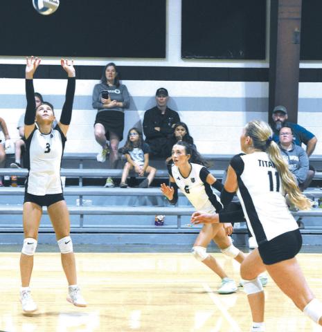 DVE's Milla Fagerholt sets up the ball, as teammates Gianna Hall and Reegan Aasand race to make the play. Photo by Jamie Rarick