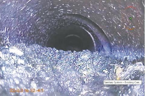Sludge buildup in the sanitary sewer is caused by slow water flow through the pipe. Slow flow allows solids to settle into the pipe and will cause sewage backup. Photo courtesy of Moore Engineering.