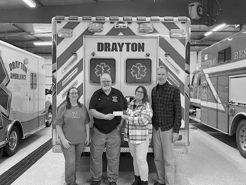 Becky Coffield PCMH Director recently presented checks to both the Drayton and Cavalier Ambulance Services for their portion of the Burgers &amp; Bingo fundraisers held throughout Pembina County. Each squad received $2,640.75 Pictured L to R: Amber Green, Bill Tuttle, Becky Coffield, &amp; Robbie Boll. Submitted photo