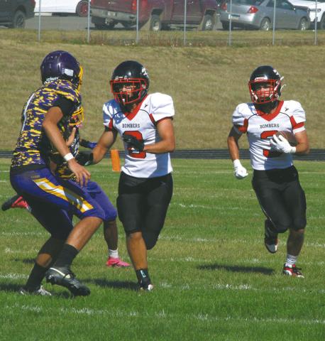 Bomber linebacker Carter Johnson clears the way for teammate Trenten Keena to make a run against the Eagles defense. Photo by Jamie Rarick
