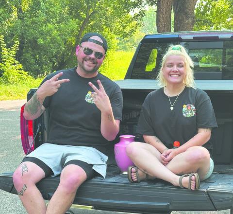 Rob and Nicole Louthain sit with their daughter Katarina's urn before the inaugural Katarina's Sunshine Ride on Saturday at Turtle River State Park near Arvilla. More than 100 participants joined the approximately 115-mile ride honoring Katarina’s memory and raising awareness about impaired and distracted driving.