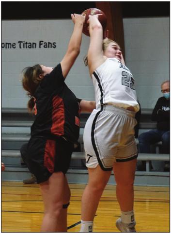 Ella Kittelson fights for a rebound against a Warrior defender. VNV Photo by Lyle Van Camp