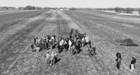 Farmers view a soil pit as part of an on-farm soil health research project. NDSU photo.