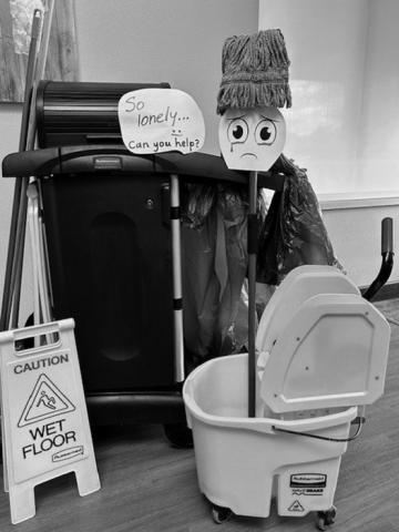 A lonely (and homely) Mr. Mop and his cart.