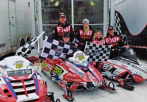Hunter Johnson pictured with his three championship flags and the Johnson Racing sleds. Pictured left to right Hunter Johnson, Scott Johnson (back), Amber Johnson, Madison Phillips, and Jaden Haagenson Photo submitted by Johnson Racing