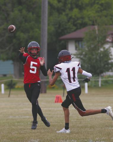 Senior quarterback Max Foss-Pokrzywinski gets the pass off over a White Shield defender. Photo by Jamie Rarick
