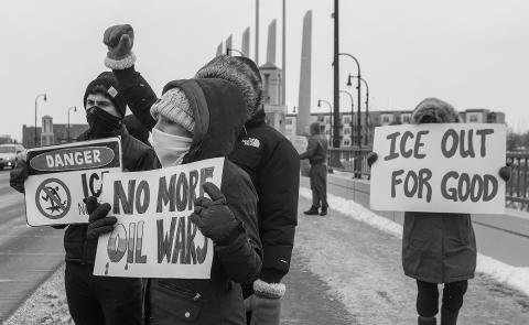 Protestors hold up homemade signs along the Veterans Memorial Bridge in Fargo on Saturday, Jan. 10, 2026, during a protest of ICE and the US involvement in Venezuela. Alyssa Goelzer / The Forum