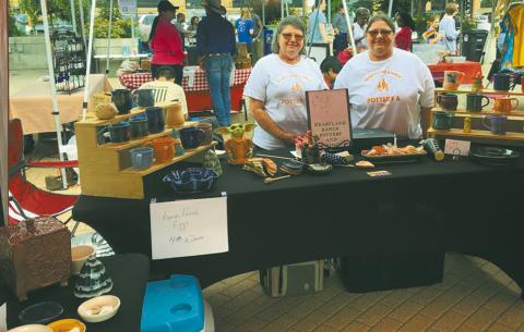 Elizabeth Linster and her sister, Sherry selling Heartland Ranch Pottery at a street fair. Submitted photo.