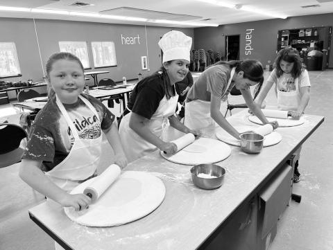 Youth campers make tortillas and pizza dough from scratch at a North Dakota 4H Camp last year in Washburn. Camp participants also took part in a Healthy Camp Challenge where all children received pedometers to track their daily step total while in camp. Photo provided by NDSU Extension.