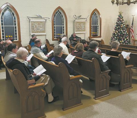 Attendees filled the pews last year for the Carol Sing at the beautifully decorated Hallson Church.
