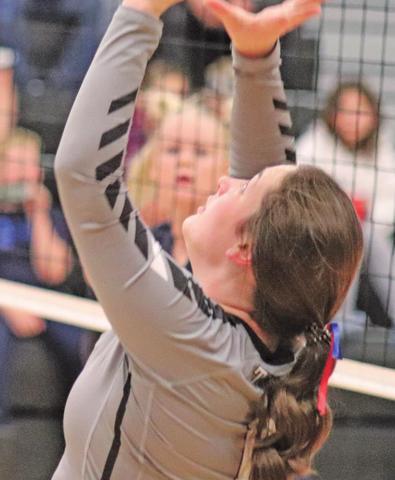 Madison Hermanson sets the ball for a teammate against the Patriots. VNV Photo by Lesa Van Camp
