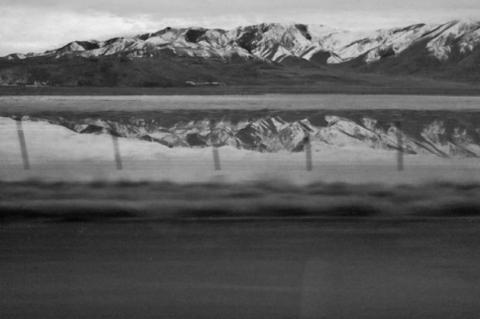 Scene along I-80 West; Mountain Range reflected by water. Photo submitted by Clint Van Camp