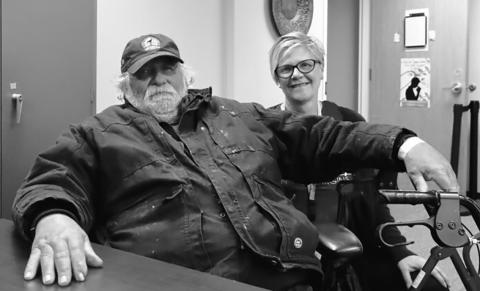 Michael Hauck, 64, left, a homeless veteran, sits next to Kris Morrissette, behavioral health manager at Ministry on the Margins in Bismarck, before being transported to a nearby hotel as he awaits approval to move into a nearby apartment on Nov. 6, 2025. (Photo by Michael Achterling/North Dakota Monitor)