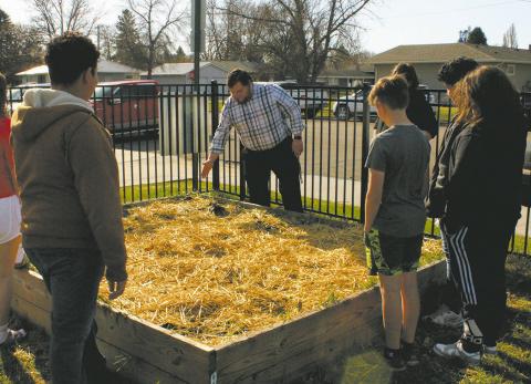 Mr. Riddle, leading a lesson in agriculture with the seventh graders at DPS community garden. Photo by Jamie Rarick