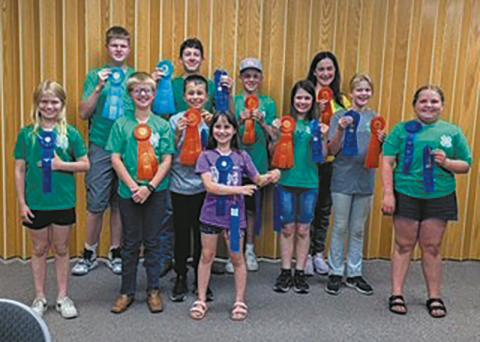 Front row (L-R): Sadie Halverson, Levi Norrell, Nathan Stegman, Olive Truver, Chloe Hunter, Stella Norrell, Lainy Shane; back row: Chaz Halverson, Chris Longtin, Spencer Berg, and Naomi Stegman.