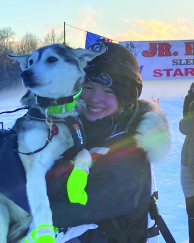 Robinson poses for a photo with one of her diva dogs upon completion of the Junior Iditarod.