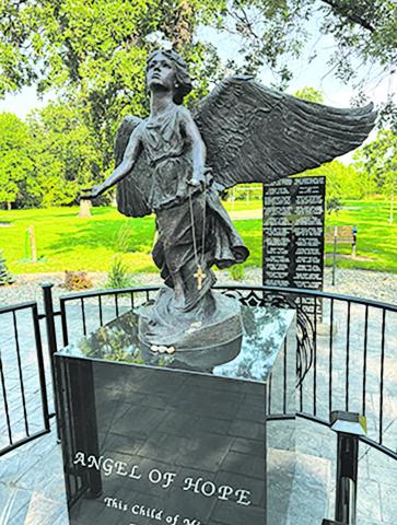 The Angel of Hope monument in Leistikow Park is adorned with memorial trinkets left by loved ones. Photo by Andrea Johnston