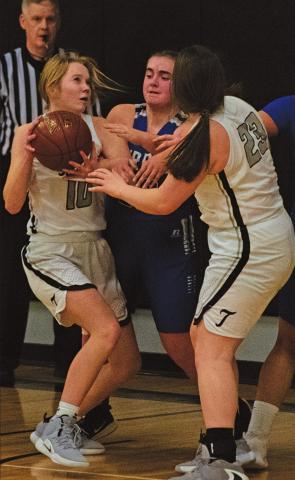 Easton Larson and Madison Hermanson battle under the basket with a couple Burros players. VNV Photo by Lesa Van Camp