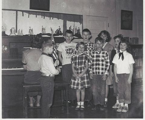 Clint holding American flag at District 13 school in 1955. Submitted photo