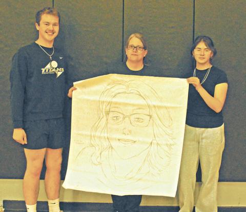 Maddox Oihus and Allisson Chavez represented the junior class for the drawing contest during Friday's spirit week activities. They won with their portrait of Drayton School Secretary Denise Cole. Photo by Jamie Rarick.