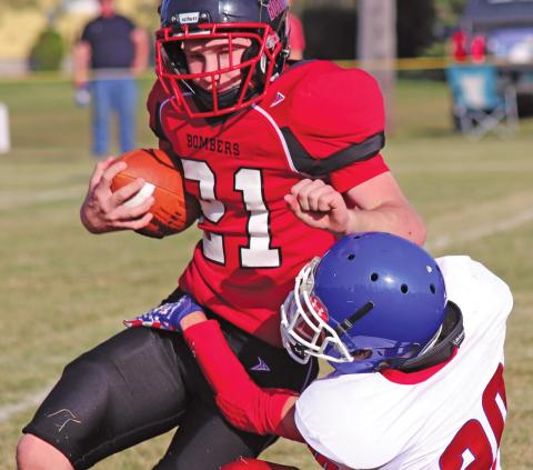 Cayden Quibell attempts to gain some yards before being taken down by Wildcat Jack Sailer in Saturday afternoons match up on the Drayton grid iron. VNV Photo by Lesa Van Camp