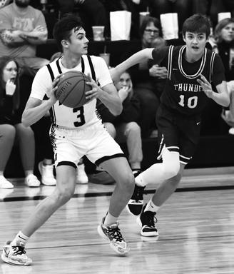 Everett Fedje and Calvin Otto try to stop Hatton-Northwood's Derek Carpenter. Photo by Lyle Van Camp.