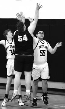 Jack Langerud and Jonathan Dusek try to block North Border's Cody Eisenbeis' shot late in the game. Photo by Lyle Van Camp.
