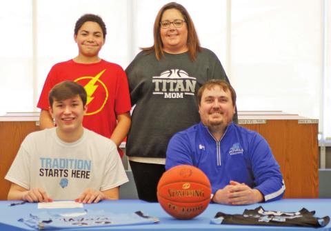 Gage Pollestad poses with his family and Coach following signing his intent to play basketball for Lake Region State College. Pictured front row I to r: Gage Pollestad and Royals Coach Jared Marshell, back row: Mason and Lindsay Pollestad. VNV Photo by Lesa Van Camp