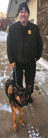 Freeway the “community dog” and his dad Officer Mattice. Photo by Christine Jensen