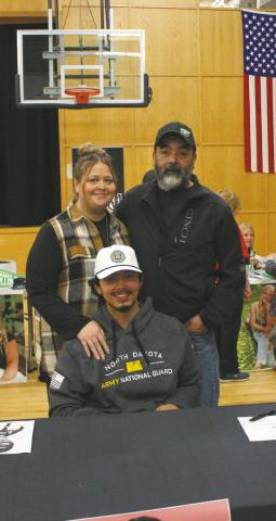 Juan Nevarro, with his parents representing the Army National Guard at Senior Signing Day at DPS. Photo by Andrea Johnston