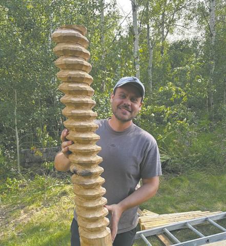 Woodcrafter Talon Stammen with a partially completed wood screw for the apple cider press. Submitted photo