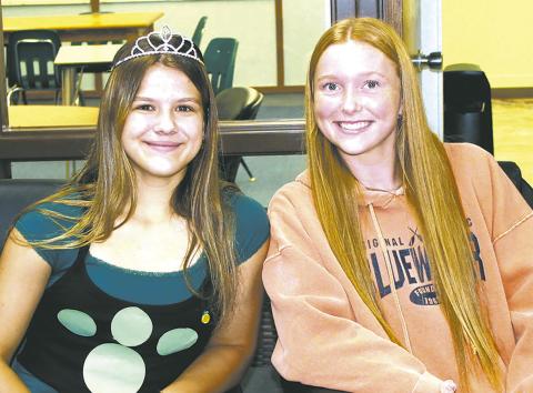 Representing the sophomore class, Violet Hoyles and Peyton Larson volunteered at the check-in table for Wednesday's blood drive at the school. Photo by Jamie Rarick.