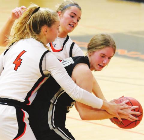 Kiara Aasand tries to fight through two Cavalier defenders. VNV photo by Lyle Van Camp
