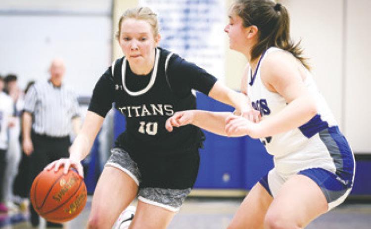 Easton Larson drives by a defender in Friday's Region 2 Play-in game in Hillsboro. Photo courtesy of Corey Erickson, Hillsboro Banner.