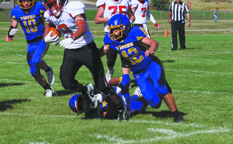 #9 Mason Pollestad drags defenders to make a big gain. Photo by Jamie Rarick